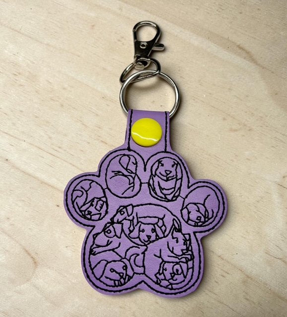 6402539f156d102fec901311_dog-paw-with-dog-faces-purple_1775991053021.jpg