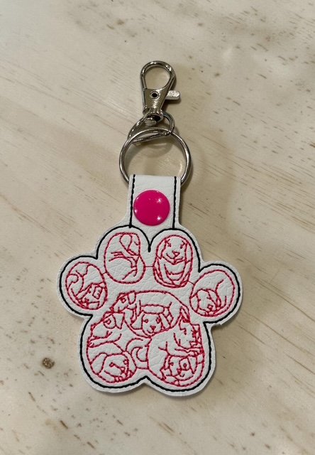 6402539f156d102fec901311_dog-paw-with-dog-faces-white-_1775991319539.jpg