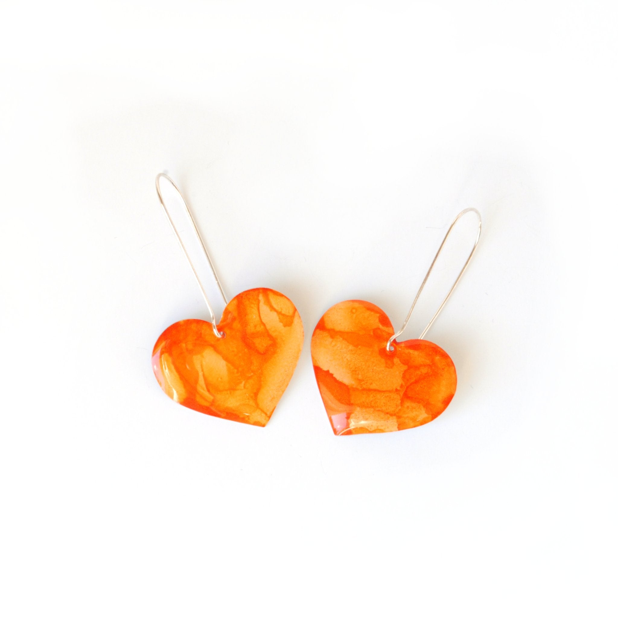 6402539f156d102fec901311_the-life-of-a-showgirl-rosy-heart-earrings-front_1779555379727.jpg